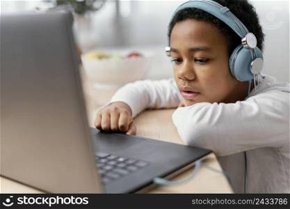 boy listening music using laptop