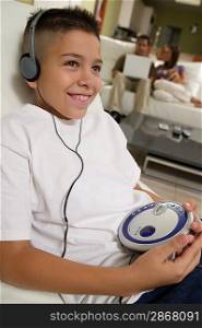 Boy Listening to Music on Portable CD Player