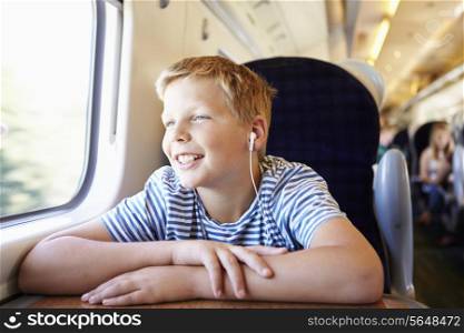 Boy Listening To Music On Train Journey