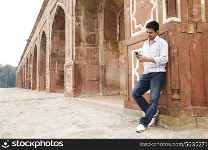 Boy looking at an sms at Humayuns Tomb