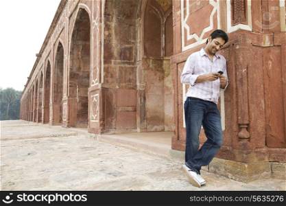 Boy looking at an sms at Humayuns Tomb