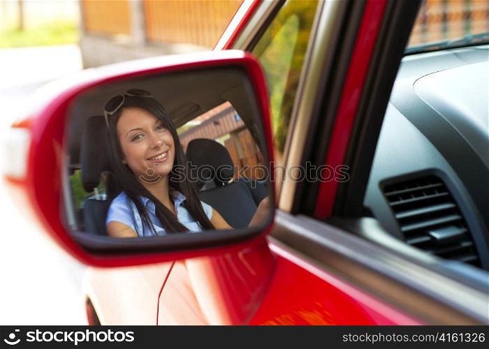 boy looking into mirrors in a car