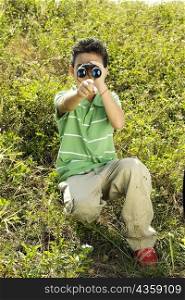Boy looking through a pair of binoculars