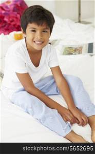 Boy Lying On Bed In Pajamas Together