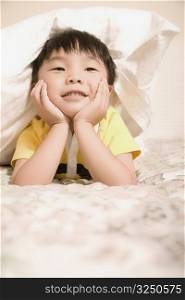 Boy lying on the bed and smiling