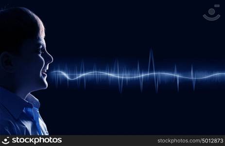 Boy making sound. Side view of boy of school age and voice coming out of his mouth