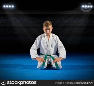 Boy martial arts fighter at sports hall