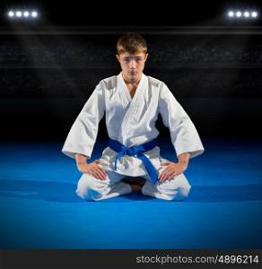 Boy martial arts fighter in sports hall