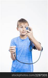 boy measuring blood pressure white backdrop