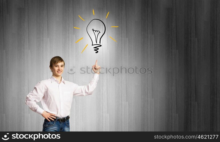 Boy of school age. Schoolboy pointing at light bulb with finger. Idea concept