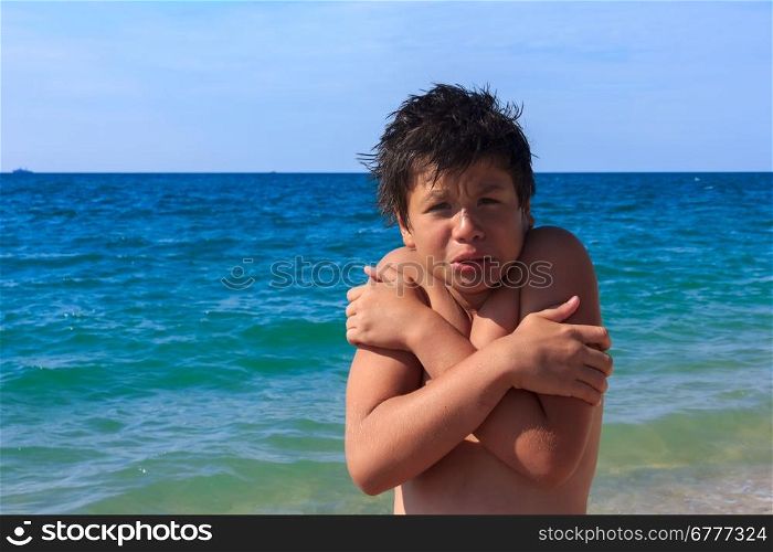 boy of twelve freezes on the sea beach