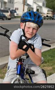 Boy on bicycle wearing cycle helmet, portrait