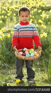 Boy On Easter Egg Hunt In Daffodil Field