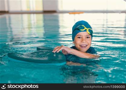 Boy on swimming class, indoor pool