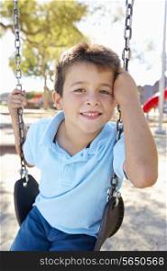 Boy On Swing In Park