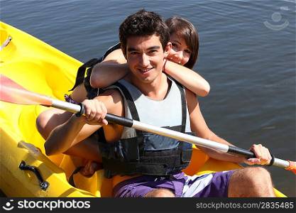 Boy paddling in canoe