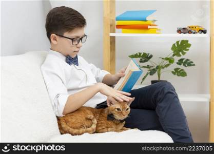 boy petting cat reading