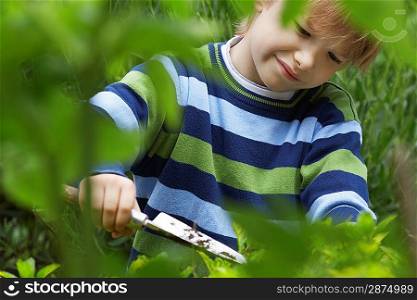 Boy Planting in Garden