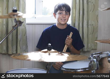 Boy Playing Drum Kit At Home