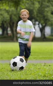 Boy playing football in a park