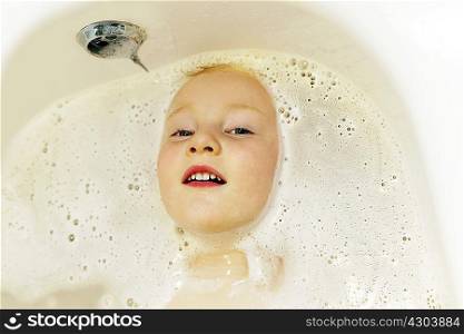 Boy playing in bath