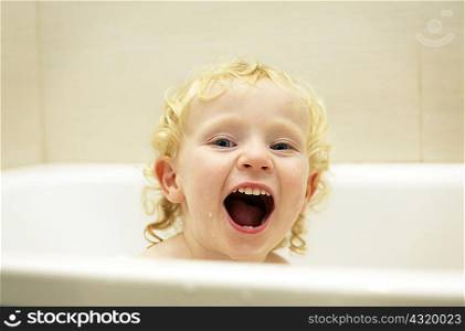 Boy playing in bath