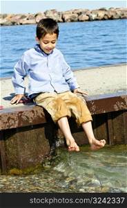 Boy playing on pier