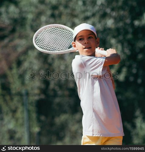 Boy Playing Tennis. Tennis Instructor with Boy in Tennis Lesson.