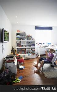 Boy Playing Video Game In Bedroom
