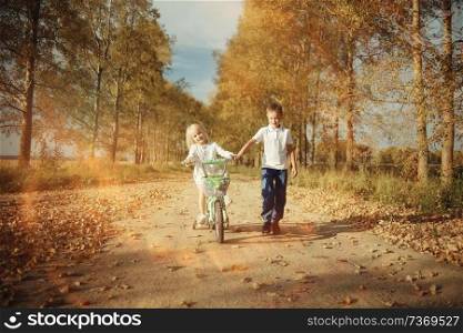 boy playing with a girl in the autumn on the outside
