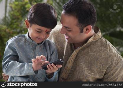 Boy playing with a mobile phone