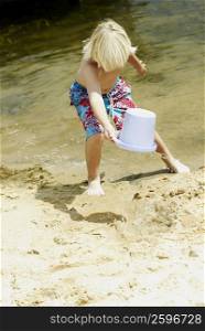 Boy playing with a sand pail