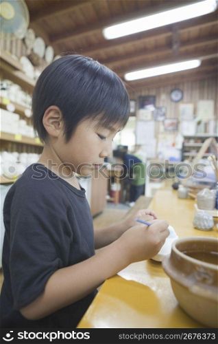 Boy playing with clay
