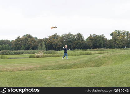 boy playing with kite long shot