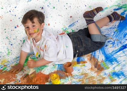 Boy playing with painting with the background painted