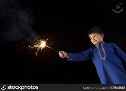Boy playing with sparkler