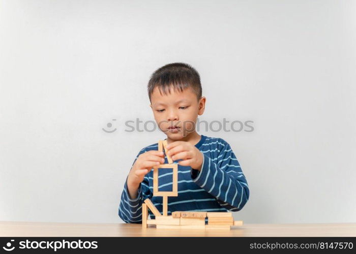 boy playing with wooden blocks at home