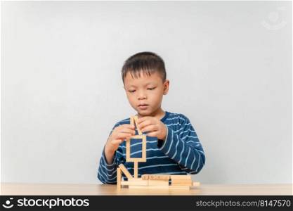 boy playing with wooden blocks at home