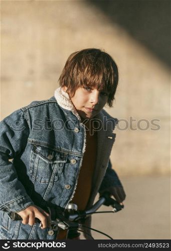 boy posing outdoors city while riding his bike 2