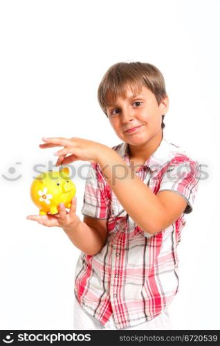 boy puts the coin into the piggy bank isolated on white
