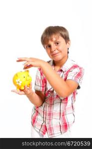 boy puts the coin into the piggy bank isolated on white