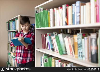 boy reading shelves