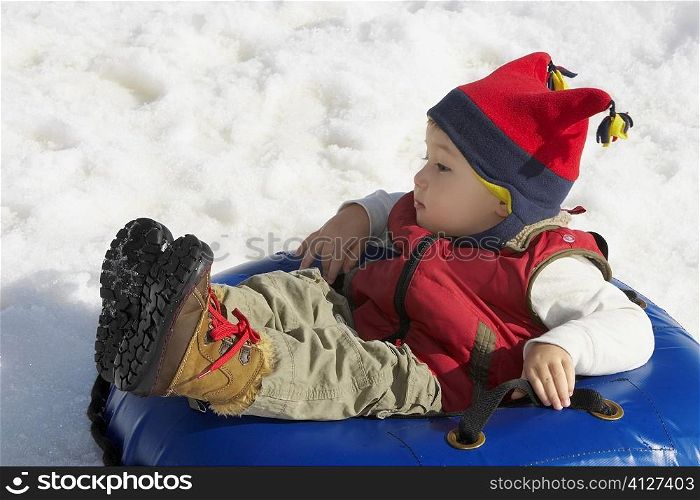 Boy reclining in an inner tube
