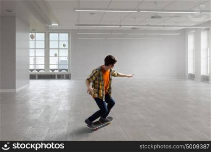 Boy ride skateboard. Active guy riding skateboard in modern interior. Mixed media