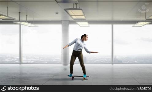 Boy ride skateboard. Active guy riding skateboard in modern interior. Mixed media . Mixed media