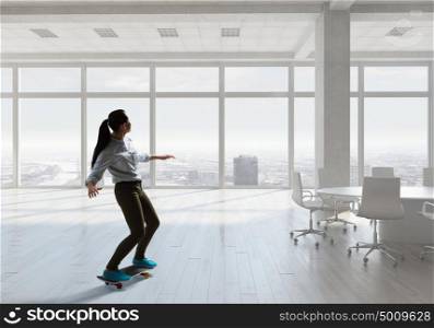 Boy ride skateboard. Active guy riding skateboard in modern interior. Mixed media . Mixed media