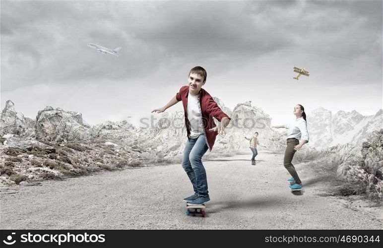 Boy ride skateboard. Active guy riding skateboard on road outdoor