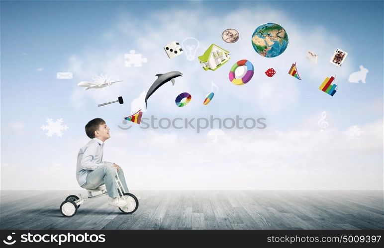 Boy riding bicycle. Little joyful cute boy riding tricycle. Elements of this image are furnished by NASA