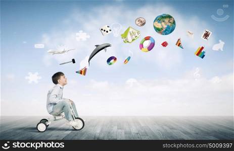 Boy riding bicycle. Little joyful cute boy riding tricycle. Elements of this image are furnished by NASA