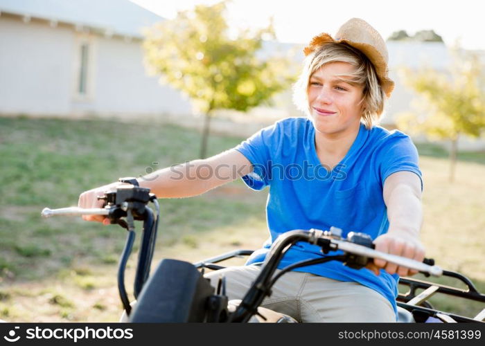 Boy riding farm truck in vineyard. Boy wearing hat and riding farm truck in vineyard